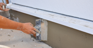 professional adding stucco to a stucco wall