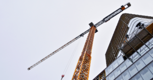 large crane working on the construction of a tall building