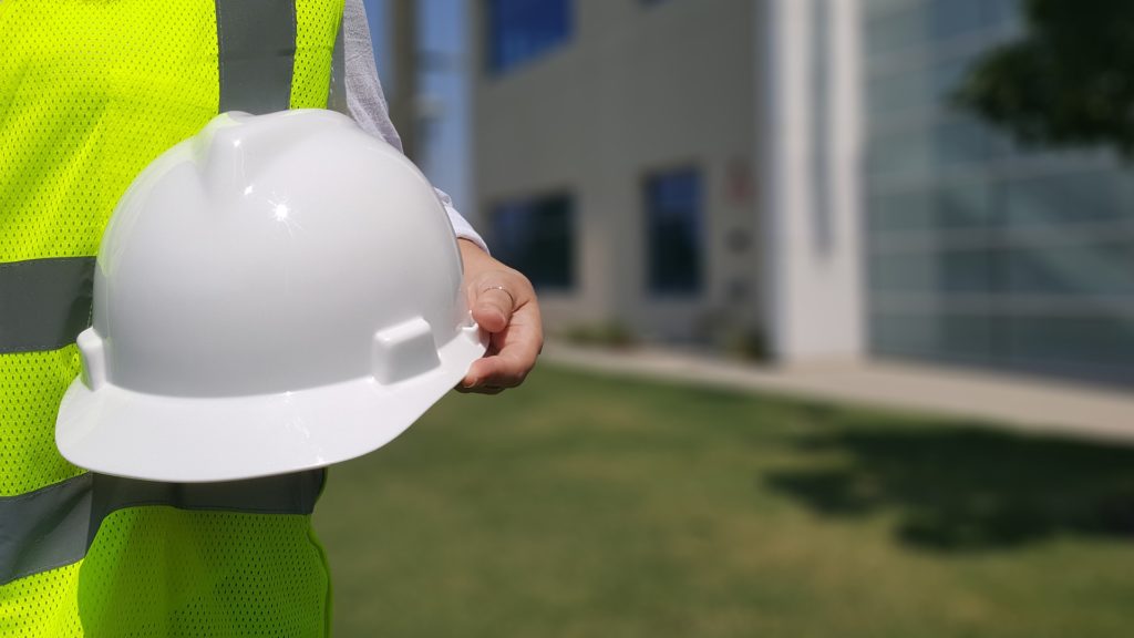 contractor holding white hard hat